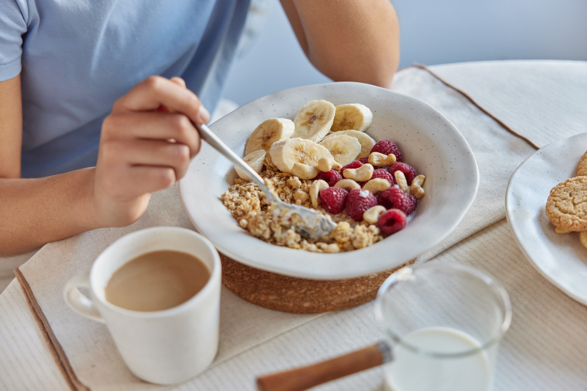 Healthy nutrition and proper nutrition concept. Unknown person enjoys oatmeal with fruits keeps to