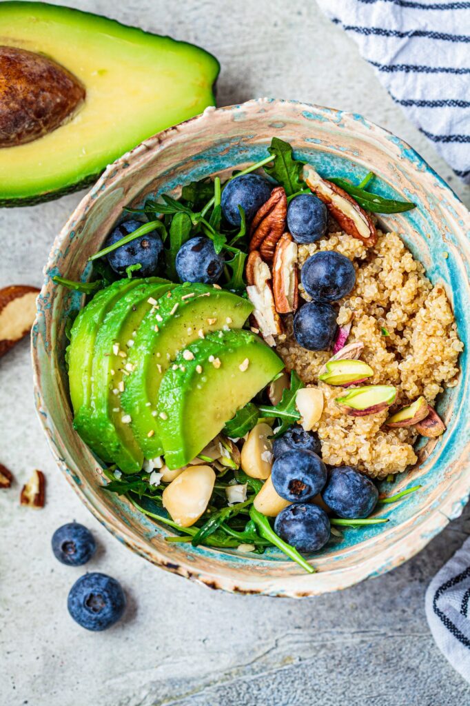 Healthy quinoa salad with berries, avocado and nuts. Healthy vegan food.