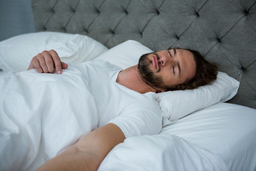 Man sleeping on his bed